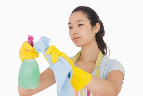 Technician performing upholstery cleaning in Romford on fabric furniture