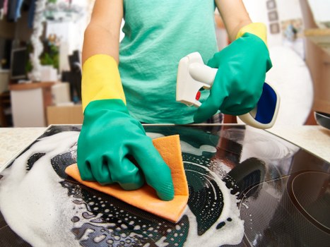 Vacuuming a mattress to remove dust and allergens in Romford
